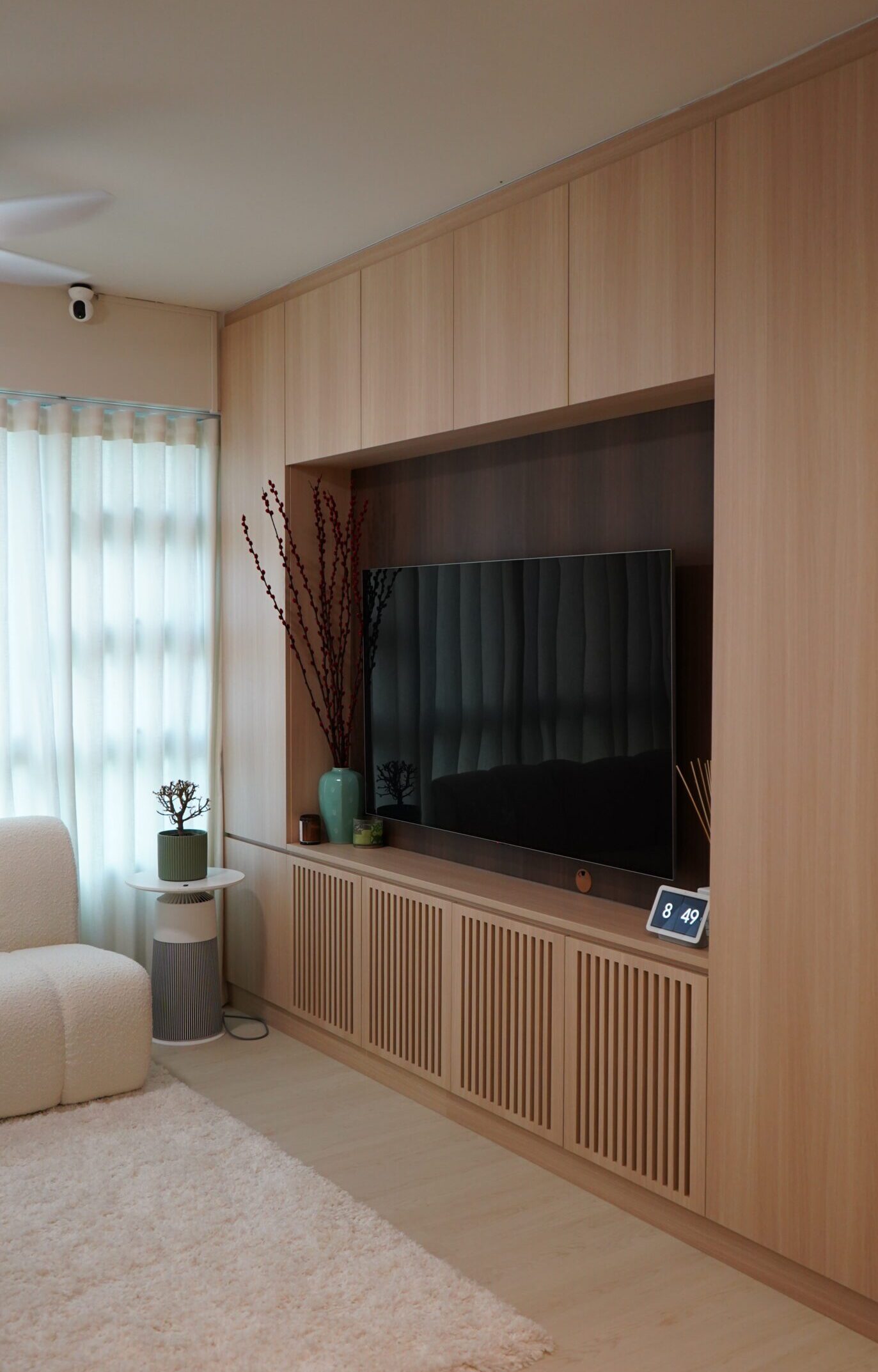 A living room with a beautiful TV console crafted by us showcasing our renovation services