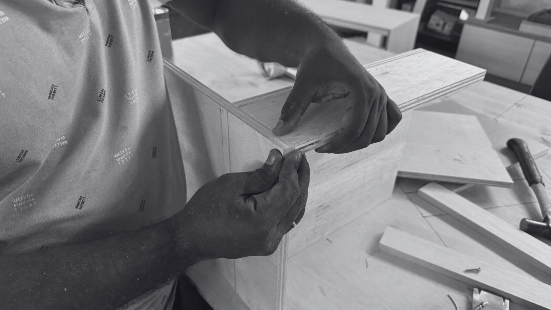 Black and White image of our carpenter working on his wooden furniture