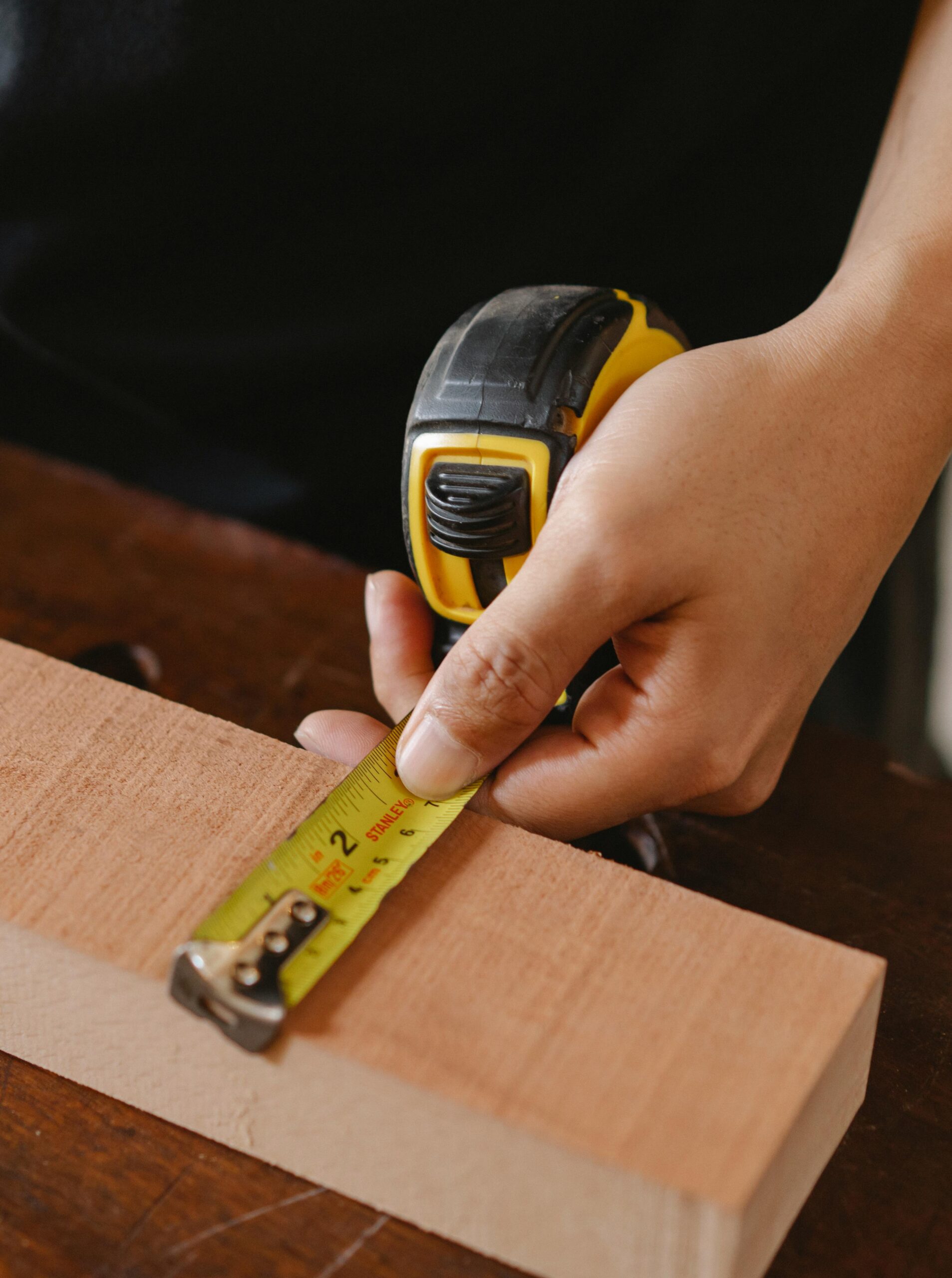 Our Carpenter measuring wood