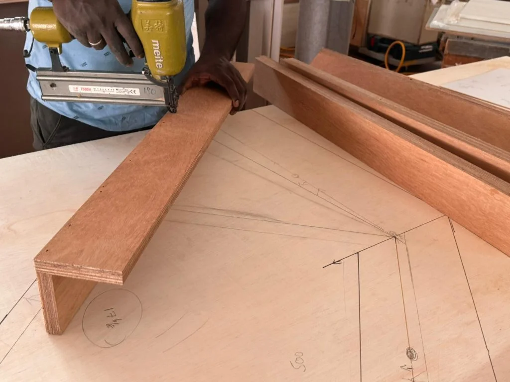 Our Master Carpenter in Singapore using staple tool for woodwork