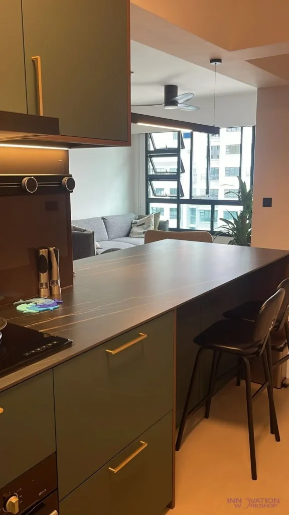 Condo renovation West Coast – kitchen breakfast bar with green cabinetry and seating