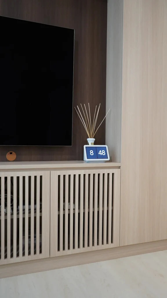 HDB renovation Telok Blangah – TV feature wall detail with dark backdrop panel and slatted cabinet doors