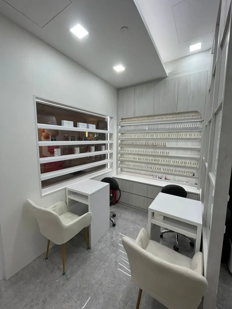 Beauty salon renovation Sengkang – nail station with LED-lit polish shelving and in-house carpentry