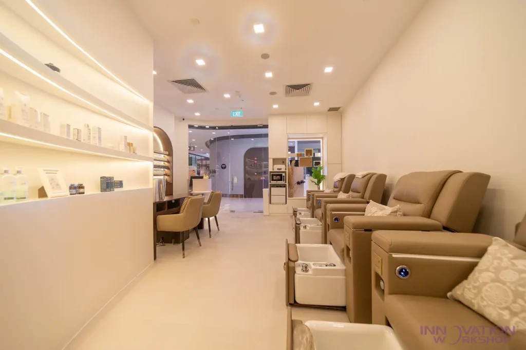 Beauty salon renovation Pasir Ris – salon interior with curved LED display shelving and nail station