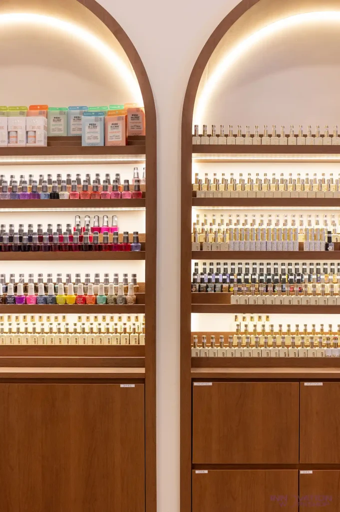 Beauty salon renovation Pasir Ris – arched timber-edged display niches for nail polish with LED lighting