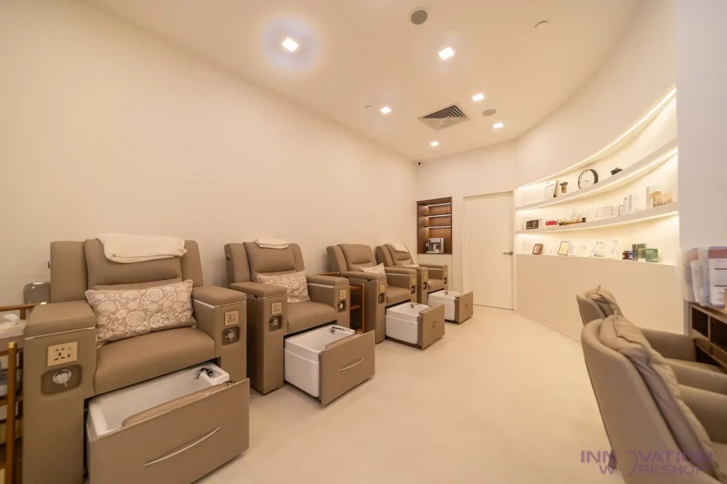 Beauty salon renovation Pasir Ris – pedicure area with curved LED shelving and slatted wall niche