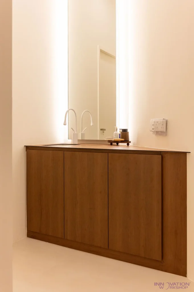 Beauty salon renovation Pasir Ris – corner vanity cabinet with backlit mirror in timber-look finish