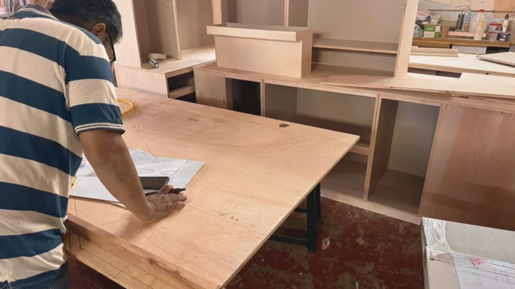 Our Head Carpenter in our workshop checking project dimensions